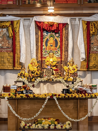 The altar at Mati Bhadra Sagara — sacred statues and offerings arranged on a carved wooden shrine